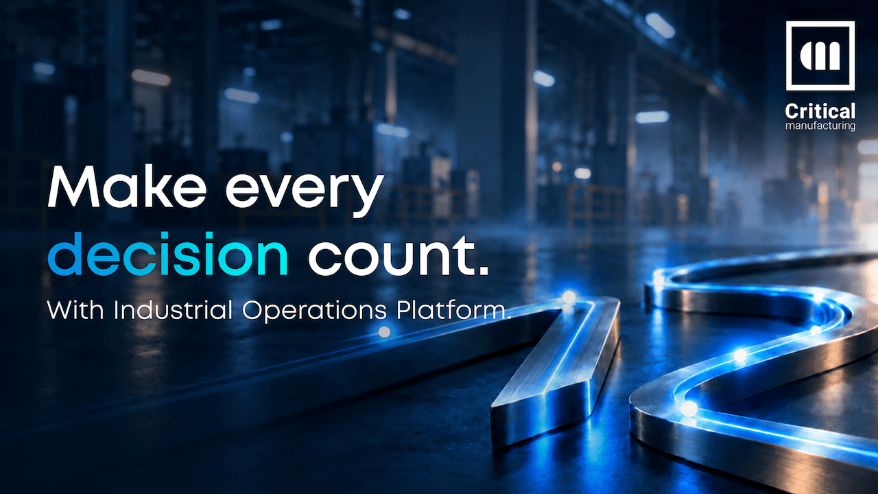 Critical Manufacturing V12 발표 배너 — 어두운 공장 바닥 위 빛나는 금속 레일과 'Make every decision count' 문구